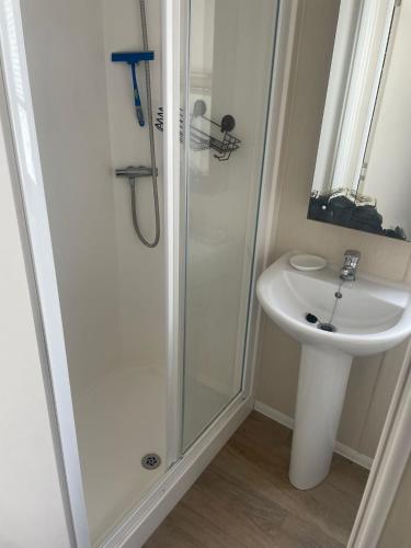 a bathroom with a shower and a sink at Caravan in Rockley Park 3 Bedrooms in Poole