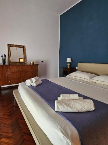 a bedroom with two beds and a mirror on the wall at La Liva in San Silvestro