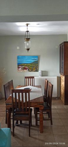 a dining room with a wooden table and chairs at Villa Aigani,maisonette, Kato Olympus, Sunrise View in Aigáni