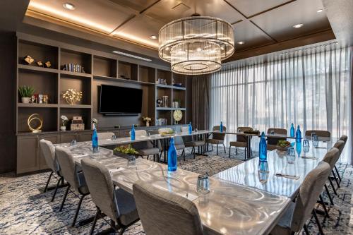 a conference room with a long table and chairs at EVEN Hotel Austin Uptown near the Domain by IHG in Austin