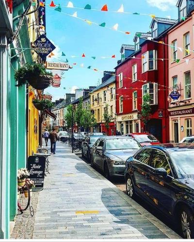 a city street with cars parked on the street at Home in Clonakilty in Clonakilty