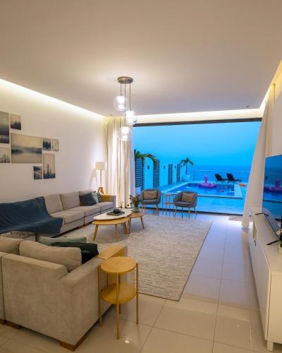 a living room with a view of the ocean at Seascape Villa in Fujairah
