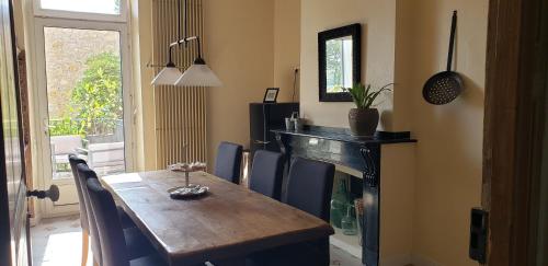 une salle à manger avec une table et une cheminée dans l'établissement Maison NOLIA - Espaces dédiés, à Fabrezan