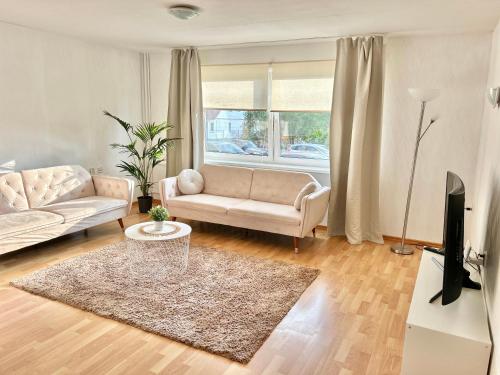 a living room with a couch and a tv at K&A apartament in Haapsalu