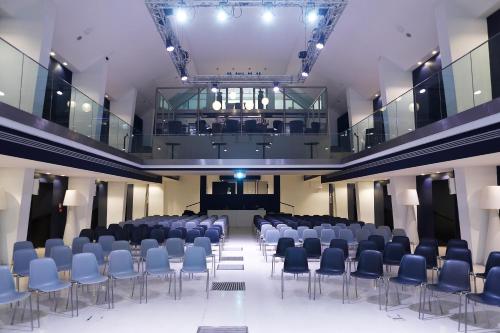 a large room with chairs and a stage in it at Rome Life Hotel in Rome