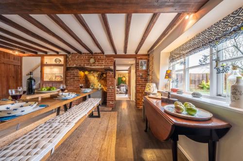a kitchen with wooden ceilings and a brick wall at Gable End in Great Snoring