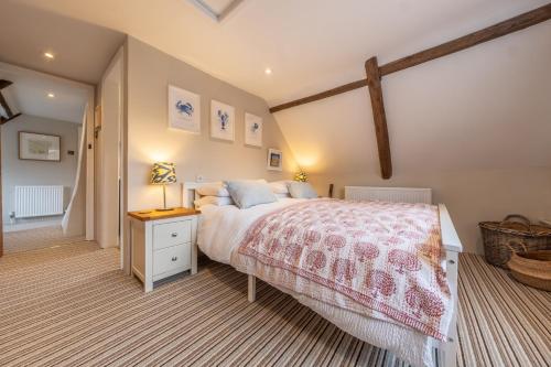 a bedroom with a large bed and a wooden ceiling at Gable End in Great Snoring