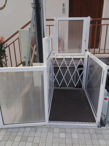 an open door with glass panels on a staircase at Stavento in Diakopto