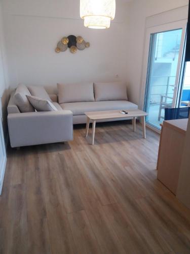 a living room with a couch and a coffee table at Stavento in Diakopto