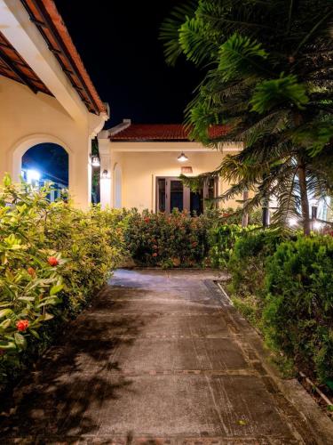 a driveway leading to a house at night at LumiGarden Tam Coc Resort in Ninh Binh
