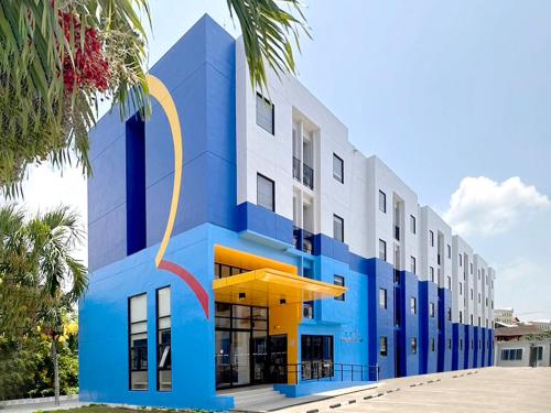 a blue and white building with a yellow and white at HOP INN Krabi Building A in Krabi town