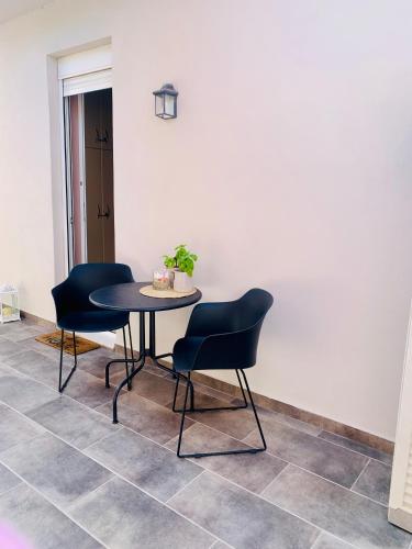 a table and two chairs in a room at Thelfi Luxury studio in Attica - close to varkiza beach - Sea view in Vari