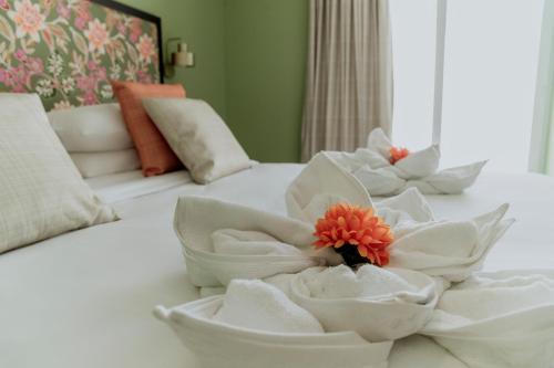 a bed with white towels and a flower on it at King Charles Hotel in Valletta