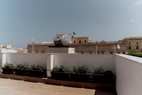 a row of plants on the roof of a building at King Charles Hotel in Valletta