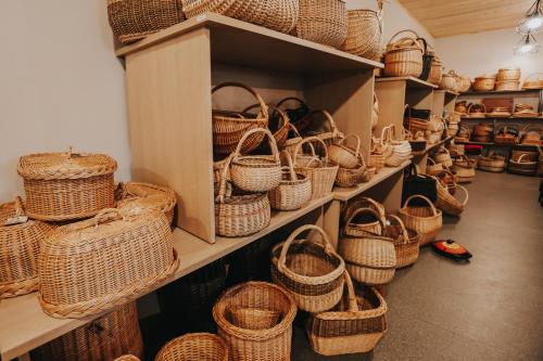 a display of baskets on shelves in a store at Weavers' Guest House Kalndaki in Milzkalne