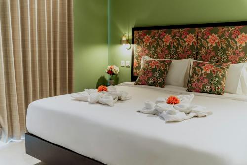 a bedroom with a large white bed with towels on it at King Charles Hotel in Valletta
