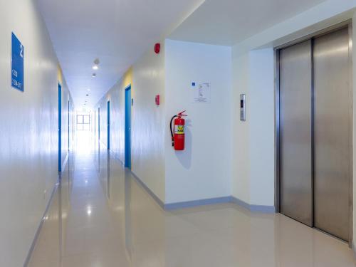 a hallway in a hospital with a fire hydrant on the wall at HOP INN Krabi Building A in Krabi town