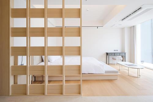 a bedroom with a wooden bunk bed with glass doors at B'amu Hotel in Busan