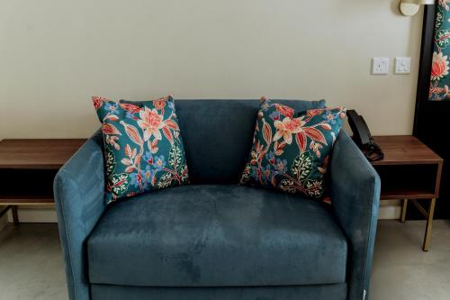 a blue couch with two pillows on it at King Charles Hotel in Valletta