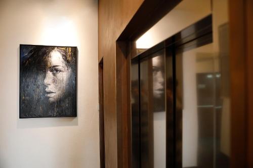 a painting of a woman hanging on a wall at Rome Times Hotel in Rome