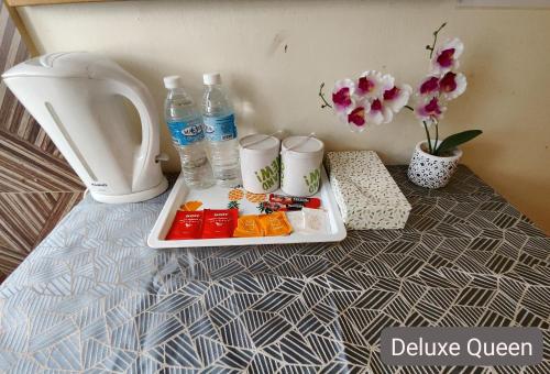 a tray of food on a table with water bottles at SCC Hotel City Centre in Kuala Lumpur