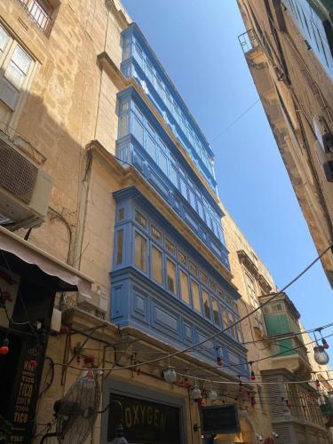 a blue building on the side of a building at King Charles Hotel in Valletta