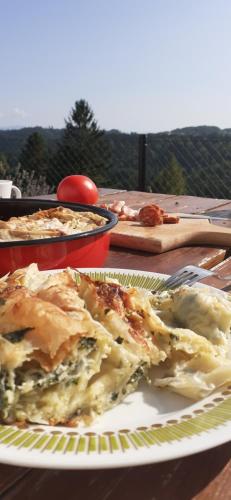 a table with a plate of food on a table at Tara Suncani sjaj-planinska kuca in Šljivovica
