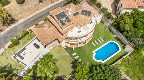 an aerial view of a house with a swimming pool at Grand villa with pool, BBQ & stunning view by REMS in Arroyo de la Miel