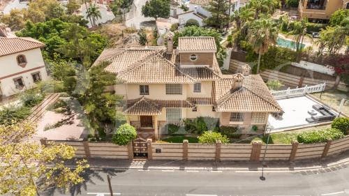 an aerial view of a house with a fence at Grand villa with pool, BBQ & stunning view by REMS in Arroyo de la Miel
