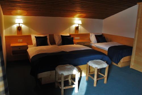 フラッハウにあるAlpenzeitのベッドルーム1室(ベッド2台、スツール2台付)