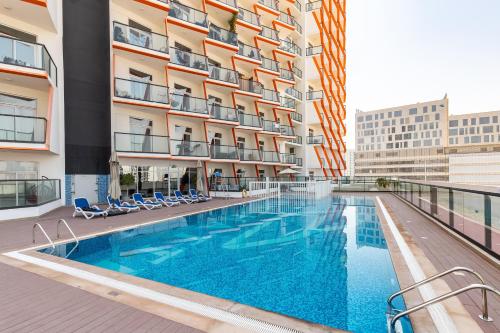 a swimming pool on the balcony of a building at Simply Comfort Vacation Homes Rental Binghatti Gateway Family 2BR with Balcony, Close to Dubai Mall & Burj Khalifa in Dubai