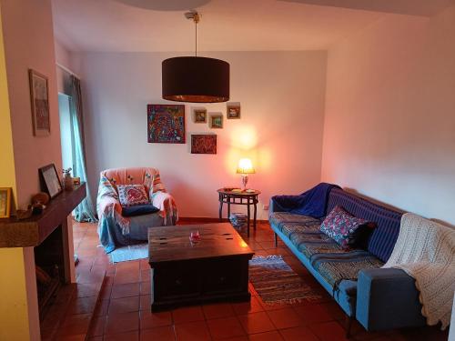 a living room with a couch and a coffee table at Casa Flow and Glow in Santiago do Cacém