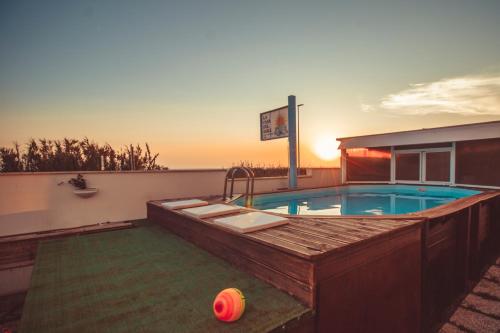 a swimming pool with a basketball on the ground at LA CASA DEL SOLE - Beachfront B&B - Anzio in Anzio
