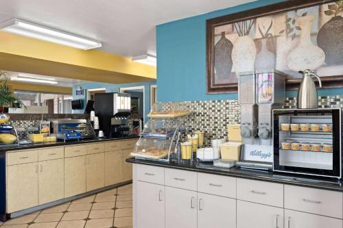 a fast food restaurant with a counter with food at Days Inn by Wyndham Conway in Conway