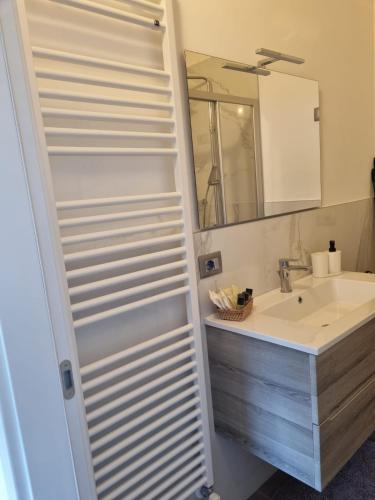 a bathroom with a sink and a mirror at Maso kreuzberg- Monolocale 3- vista montagne in Trento
