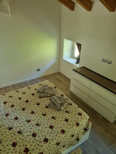 a bedroom with a bed with shoes on it at Maso kreuzberg- Monolocale 3- vista montagne in Trento