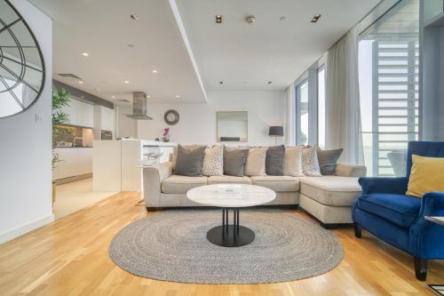 a living room with a couch and a table at Lagom Vacation Home 2 Bedroom Apartment Blue Waters in Dubai