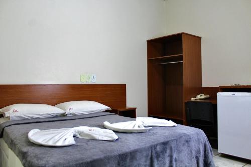 Ένα ή περισσότερα κρεβάτια σε δωμάτιο στο Hotel Cancioneiro