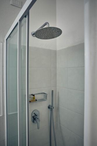 a bathroom with a shower with a glass door at Hotel Paradiso Conca d'Oro in Nago-Torbole