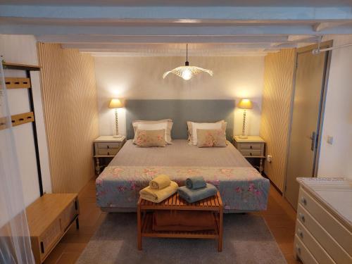 a bedroom with a bed with two hats on a table at Purple Studio in Funchal