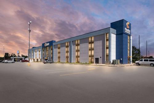 a large building with a parking lot in a parking lot at Comfort Inn & Suites Evansville Airport in Evansville