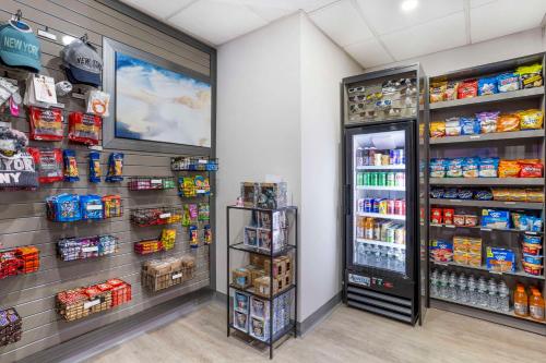 a grocery store aisle with a refrigerator and shelves of food at Comfort Inn Edgewater on Hudson River in Edgewater