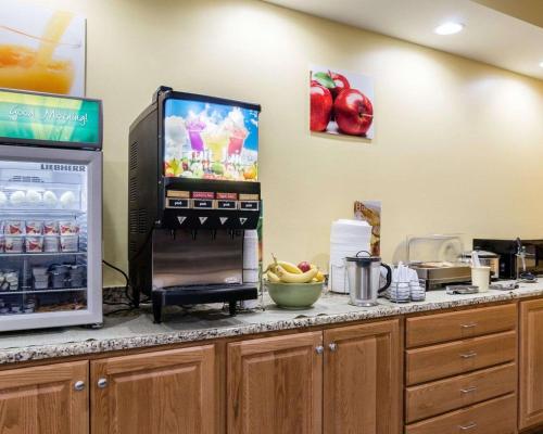 a kitchen with a refrigerator and a counter with food at Quality Inn Liberal in Liberal