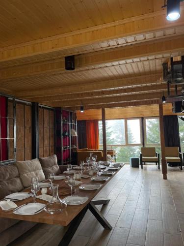 a long table with wine glasses on it in a room at Panorama Gomismta in Gomi