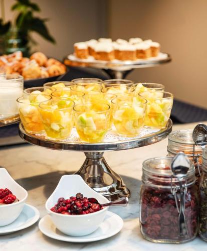 a serving platter with fruit and pastries on a table at Radisson Blu Airport Terminal Hotel in Arlanda