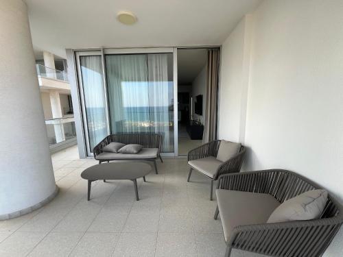 a room with chairs and tables and a balcony at Sea view in Boğaz