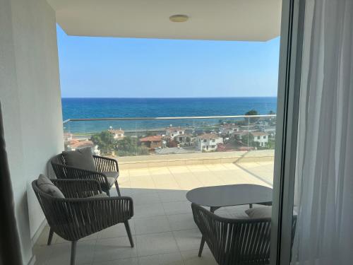 a balcony with chairs and a table and a view of the ocean at Sea view in Boğaz