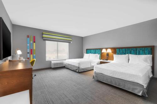 a hotel room with two beds and a television at Hampton Inn & Suites Bakersfield Central in Bakersfield