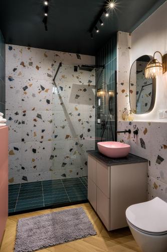 a bathroom with a toilet and a sink at Charming Apartment in a green area- free parking in Krakow