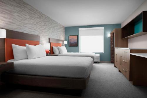 a hotel room with two beds and a window at Home2 Suites By Hilton Phoenix North Happy Valley in Phoenix